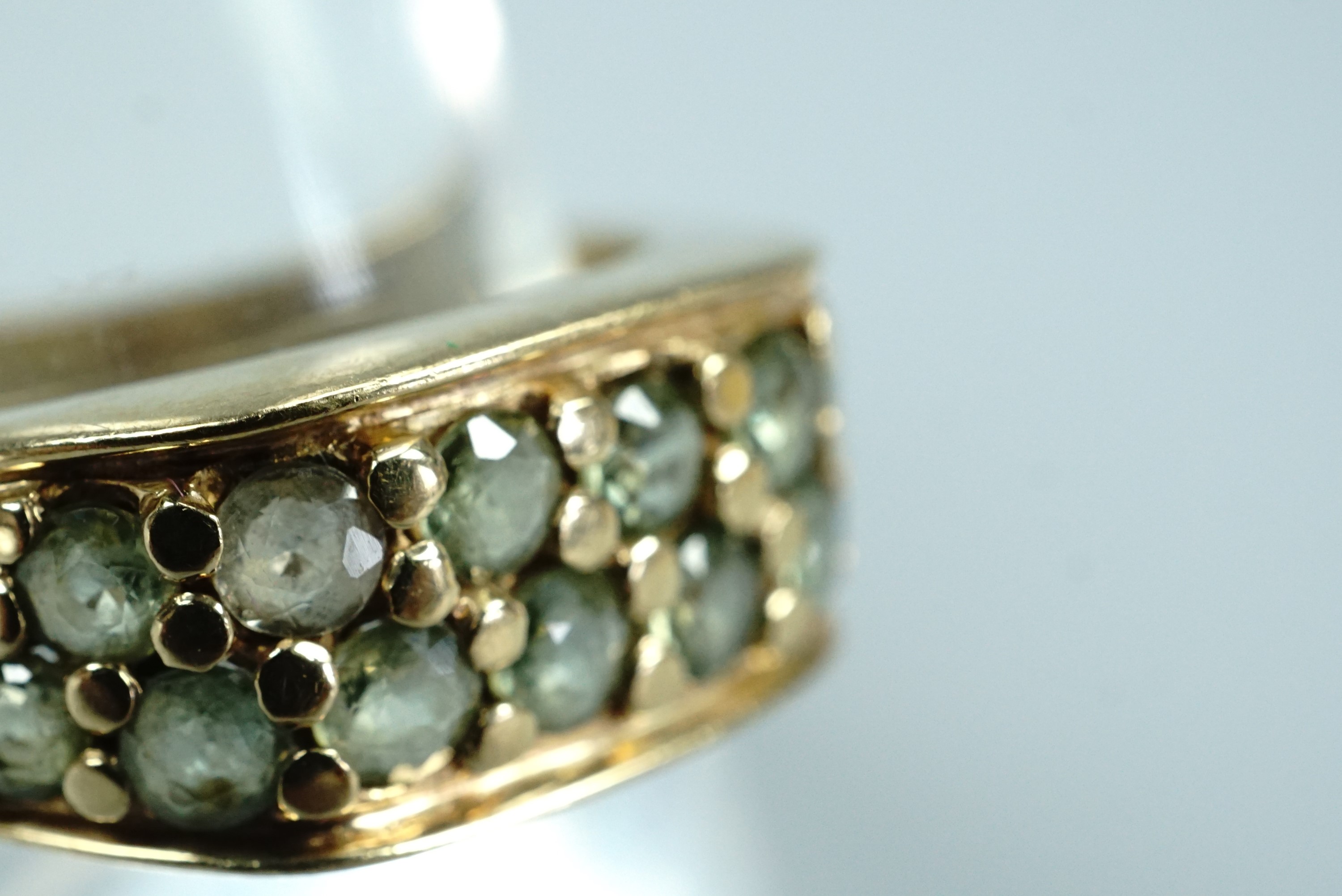 A contemporary 9ct gold and green sapphire statement ring, having two rows of pellet-set round-cut - Image 2 of 3