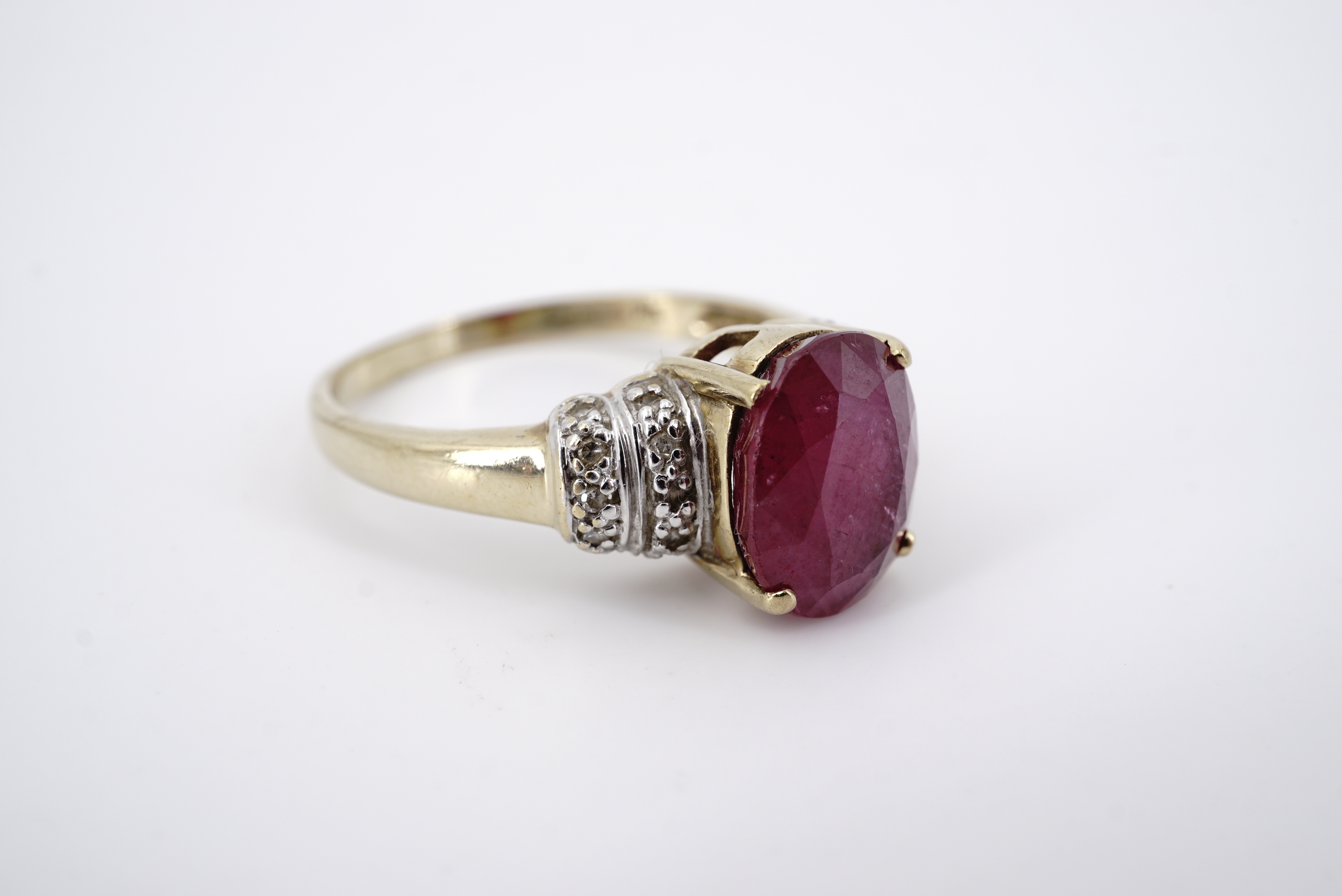 A contemporary 9ct gold ruby and diamond cocktail ring, having a central oval-cut ruby of - Image 2 of 2