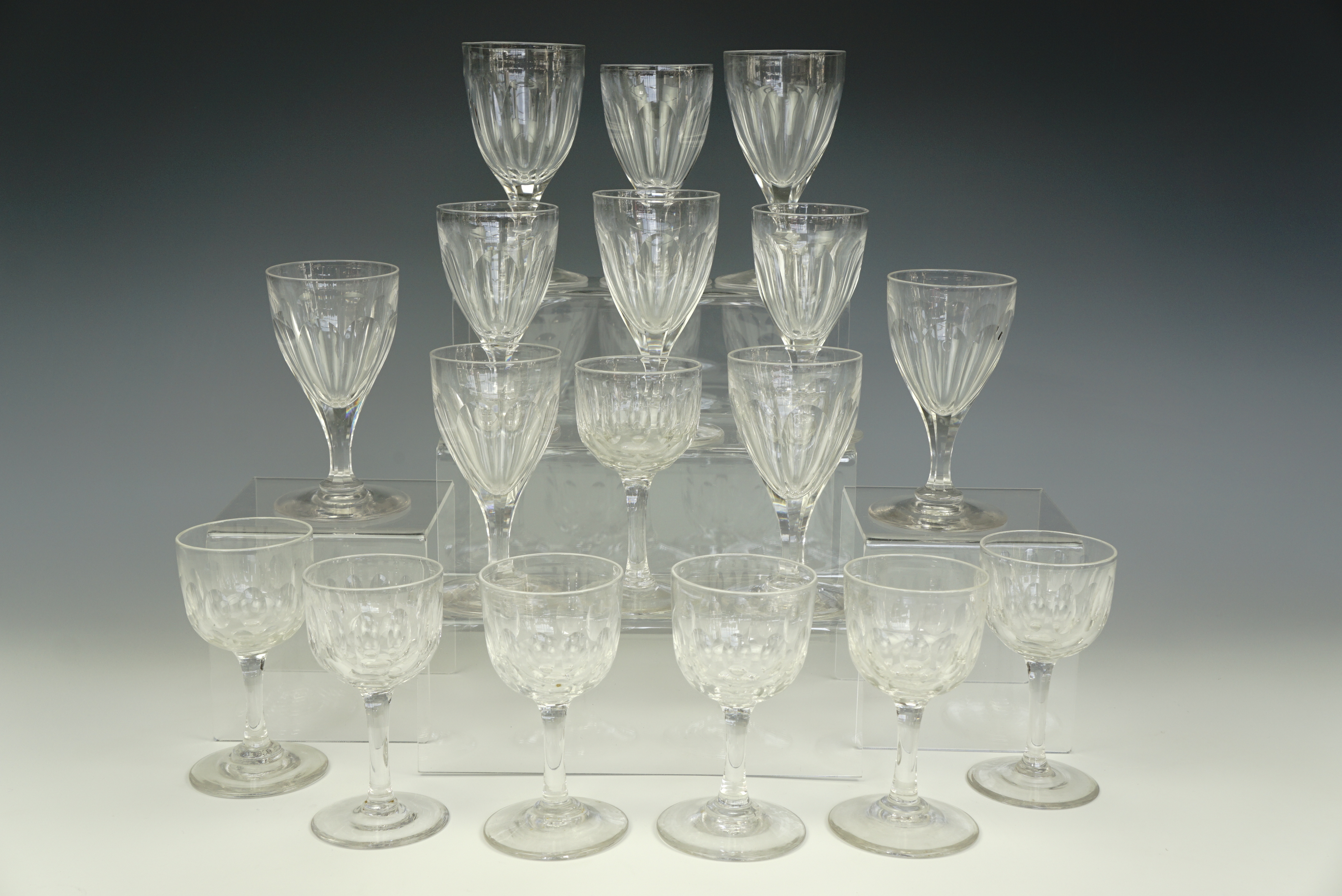 Eleven Victorian facet-cut wine glasses , appr. 11 cm, together with seven others, smaller