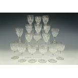 Eleven Victorian facet-cut wine glasses , appr. 11 cm, together with seven others, smaller