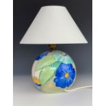 A Grey's Pottery table lamp, of spherical form, hand-enamelled with blue stylized flowers, signed '