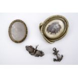 Two Victorian locket brooches, a filigree butterfly brooch and another modelled as a fouled anchor