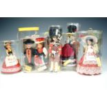 A collection of novelty world costume dolls.