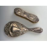 An Edwardian silver hand mirror and hair brush, decorated in depiction of peacocks, Henry