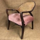 A 1930s cane-backed open armchair