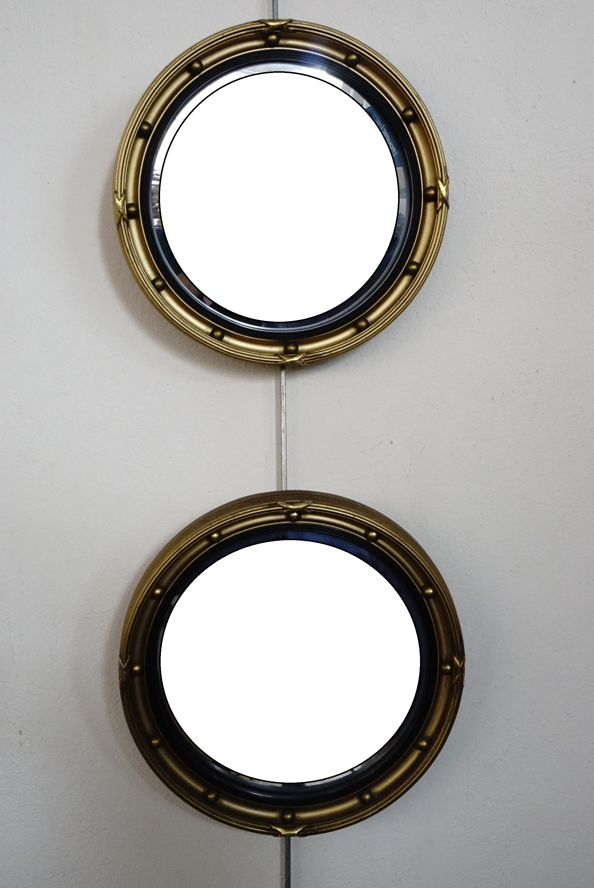 A pair of old reproduction Regency style gilt framed circular wall mirrors, 24 cm