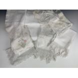 Antique domestic table linens, including damask table cloths, lace trimmed tea table and tray