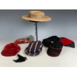 A vintage Harrow straw boater and two sports caps, together with further school and other hats