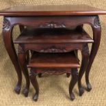 A late 20th Century nest of carved hardwood tables