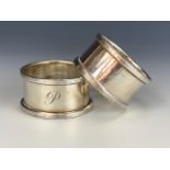 A pair of Elizabeth II silver napkin rings, engraved with the letters J and P respectively,