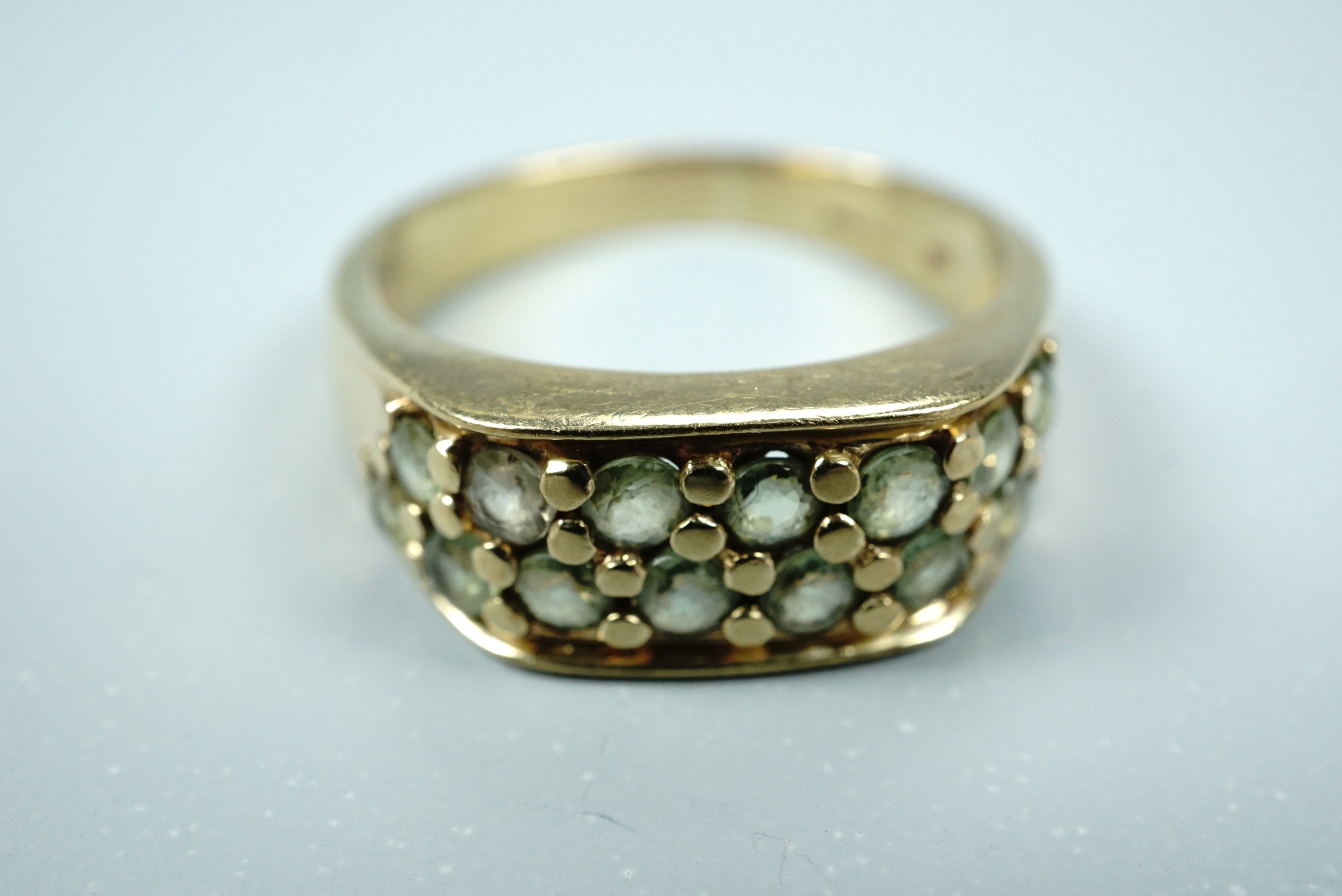 A contemporary 9ct gold and green sapphire statement ring, having two rows of pellet-set round-cut - Image 3 of 3