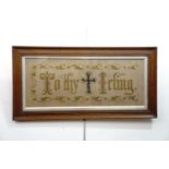 A Victorian religious text, hand-embroidered, with beadwork detail, framed under glass, 27 x 54 cm