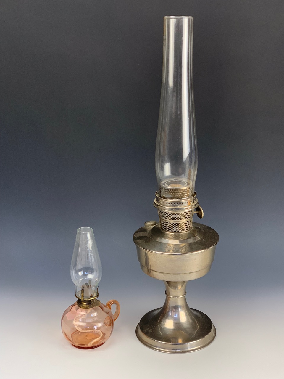 A Super Aladdin paraffin lamp together with a finger oil lamp