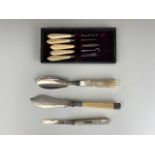 A Victorian silver butter knife, with carved mother of pearl handle, an electroplate butter knife, a