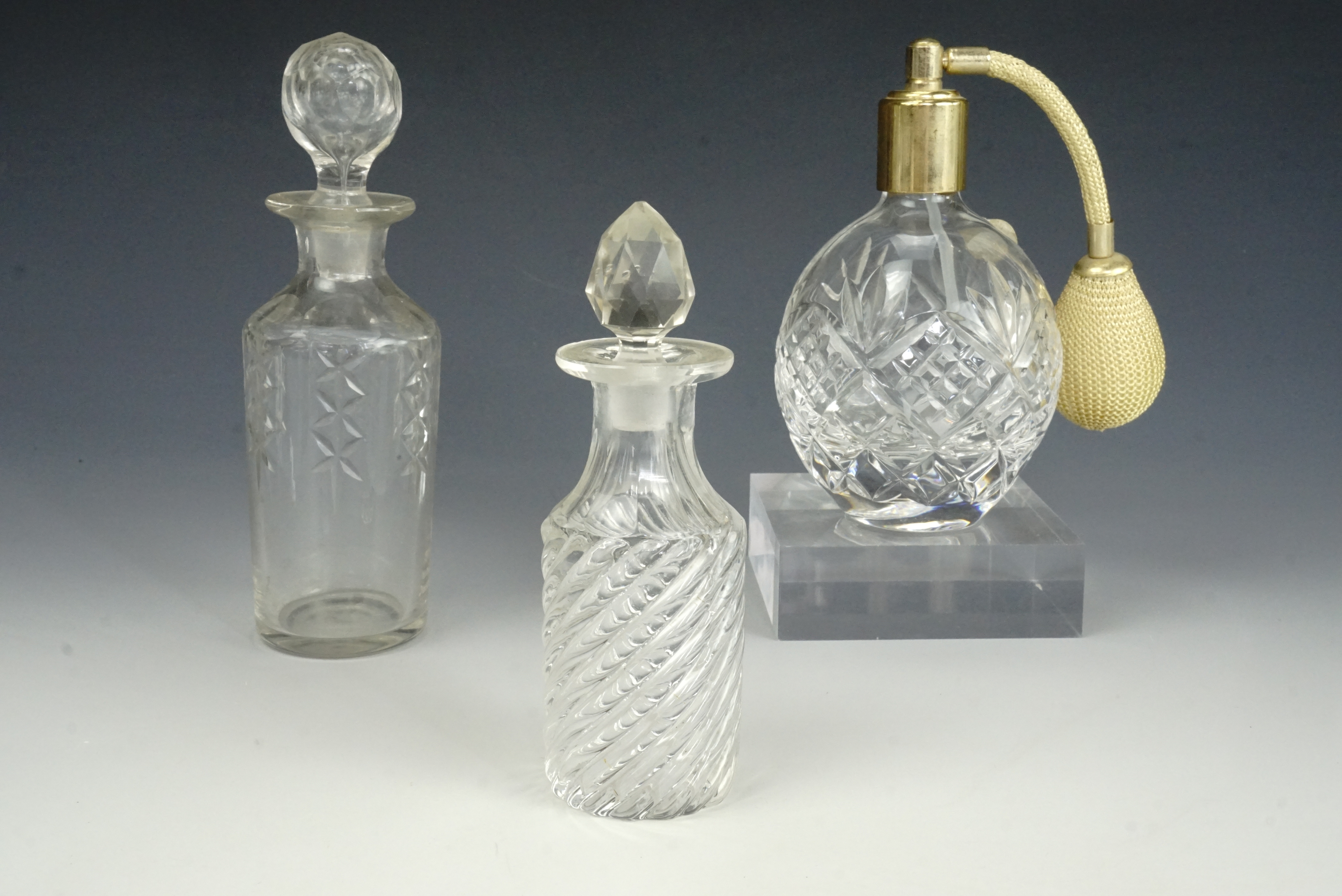 A Royal Doulton perfume atomizer and two scent bottles