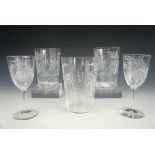 Three Victorian wheel-cut blown-glass tumblers and two matching wine glasses, each decorated with
