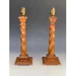 A pair of George V spirally fluted oak table lamps, 50 cm