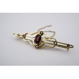 An early 20th Century yellow metal, split seed pearl and almandine bar brooch, in a openwork