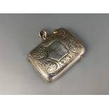 A Victorian foliate-engraved silver fob vesta case, one face centred by a shield shaped cartouche