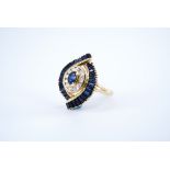 A contemporary Modernist sapphire and diamond dress ring, comprising a central oval sapphire