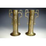 A pair of early 20th Century two-handled brass cylindrical vases, 22 cm