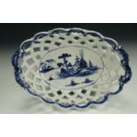 A George III blue-and-white reticulated oval porcelain basket, hand decorated in a Chinoiserie
