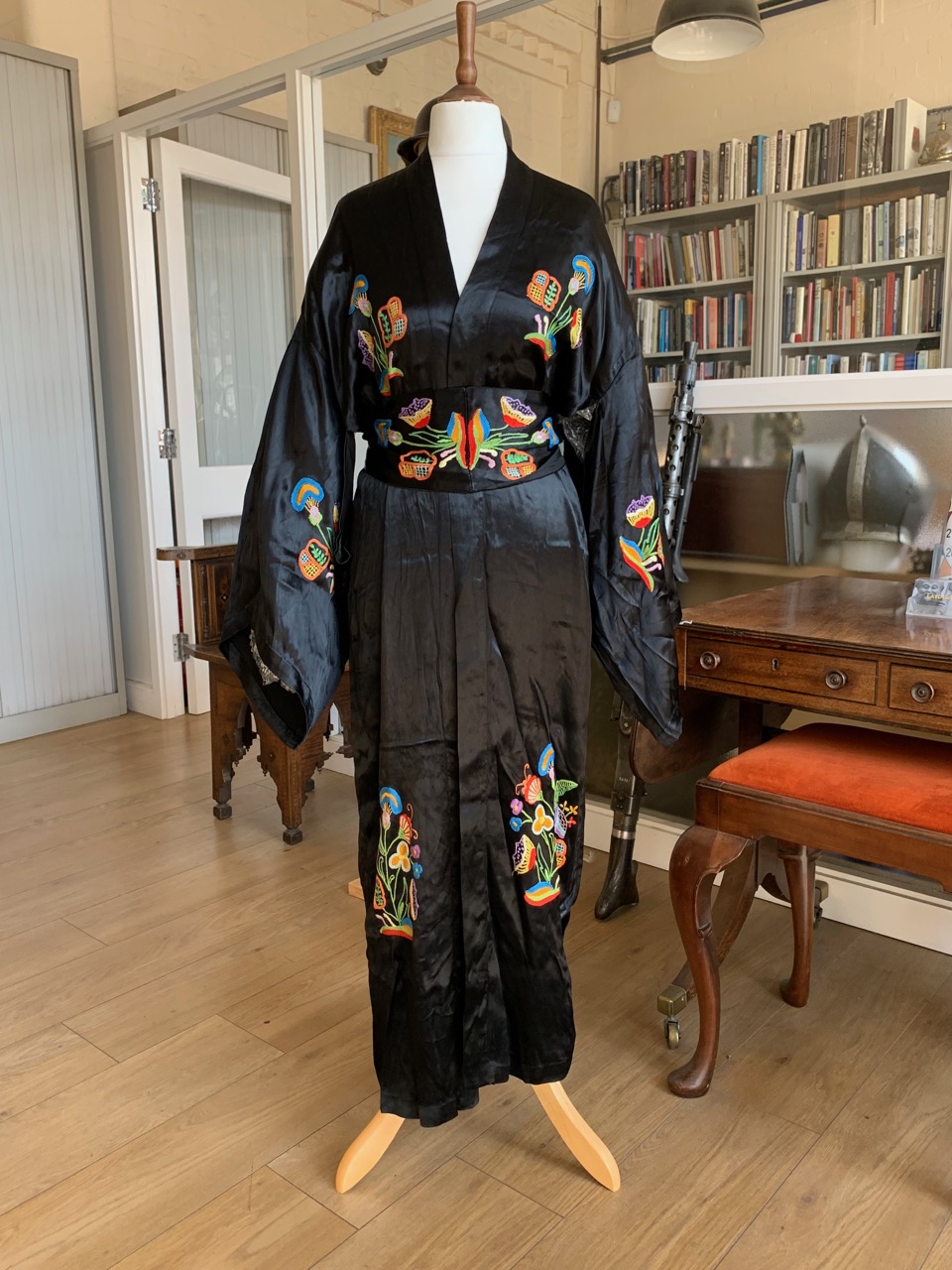 A 1930s black silk kimono, with chain stitch embroidered decoration in the form of jazzy multi-
