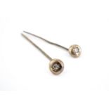 A pair of late 19th / early 20th Century lapel or similar pins, each gypsy set with a diamond