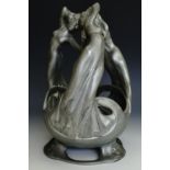 An Art Nouveau Britannia metal centrepiece, modelled as three women in flowing dresses holding hands