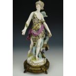 A late 19th Century Samson Meissen style figurine of a neo-classical female striding beside a