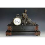 A late 19th Century French figural mantle clock, having a movement by Machenaud, in a red variegated