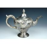 A George III Scottish silver tea pot, of inverted pear shape, raised on a stepped circular foot,