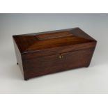 A late Georgian rosewood sarcophagus-form tea caddy, containing a pair of wooden tea canisters and a
