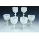 A set of six Vallerysthal milk glass wine goblets, each of round funnel form with knopped stem and