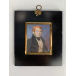 An early 19th Century portrait miniature of a red-headed young man wearing a beetle wing collar with