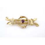 A Victorian almandine and 9 ct yellow metal bar brooch, the stone set within an annulus of inter-