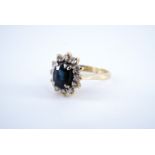 A sapphire and diamond flowerhead cluster ring, set with an oval sapphire of approx 1.6 ct, claw set