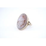 A shell cameo finger ring, the oval cameo depicting the relief profile of a classical Greek warrior,