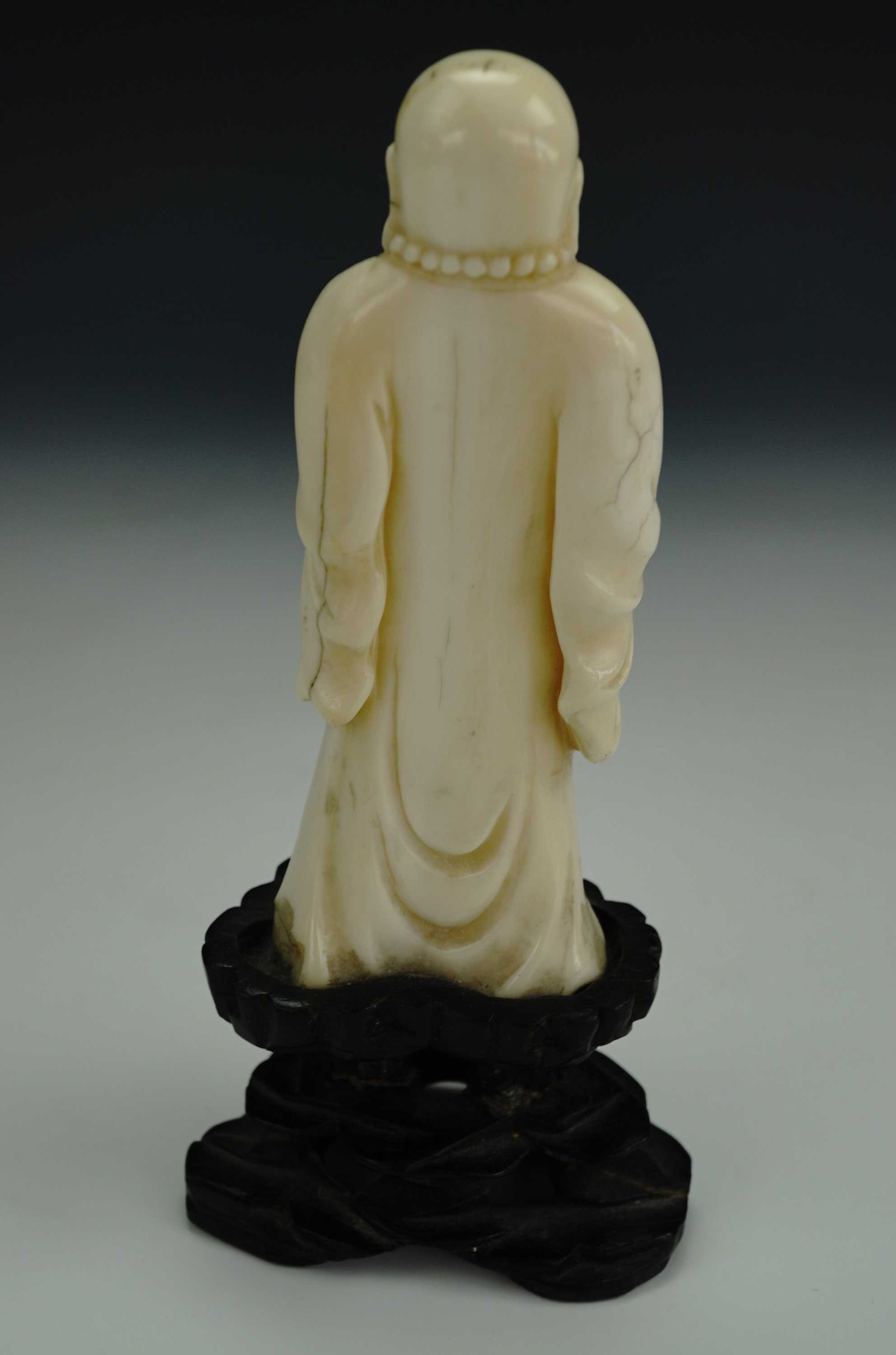 A late 19th / early 20th Century Chinese carved ivory figure of a standing Budai, in carved wooden - Image 3 of 3