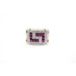 A contemporary Art Deco influenced ruby and diamond reversible dress ring, having a rectangular face