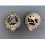 Two white metal clan badges by Carlisle silversmith Harris and McNeill, each with reticulated and