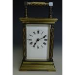 An antique French carriage clock, the brass case having spirally fluted handle and columns, late