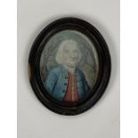 A naive watercolour portrait of an 18th Century gentleman, in oval wooden frame, the back board