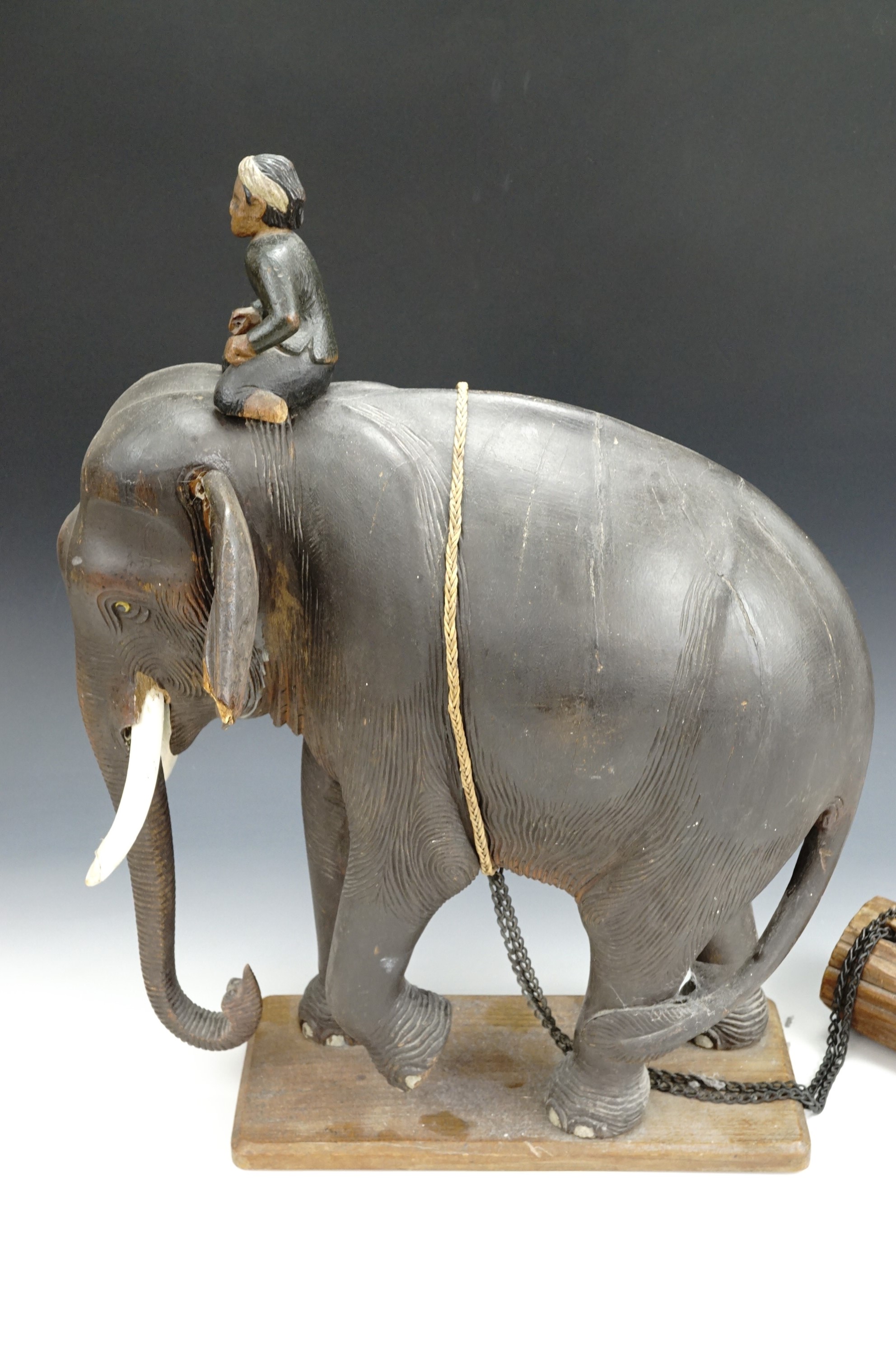 A 1930s Malayan elephant sculpture of carved wood, depicting a naturalistically modelled elephant
