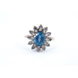 A blue topaz and diamond flowerhead cluster ring, the gems claw set on a 9 ct gold shank, M/N