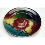 A Wemyss Ware "Jazzy" dish, decorated with a rose over a colour block ground, painted marks, No 213,