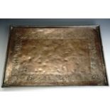 A fine Keswick School of Industrial Art copper tray, planished and decorated with an engraved border