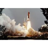 A NASA photograph of the Space Shuttle Columbia at launch, (pasted on board), 28 cm x 35 cm