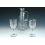 A Victorian cut glass jug and two wine glasses, decorated in depiction of wheat and flower