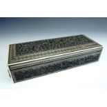 An antique Indian Sadeli ware glove or similar box, the cover and sides having carved panels
